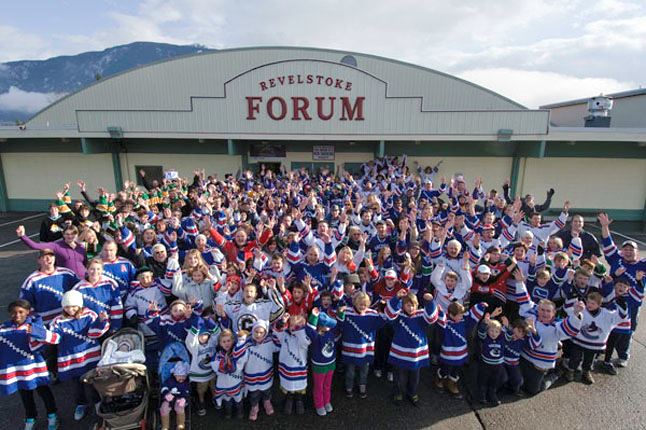 Group of fans wearing hockey jersey standing in front of the Revelstoke Forum Arena